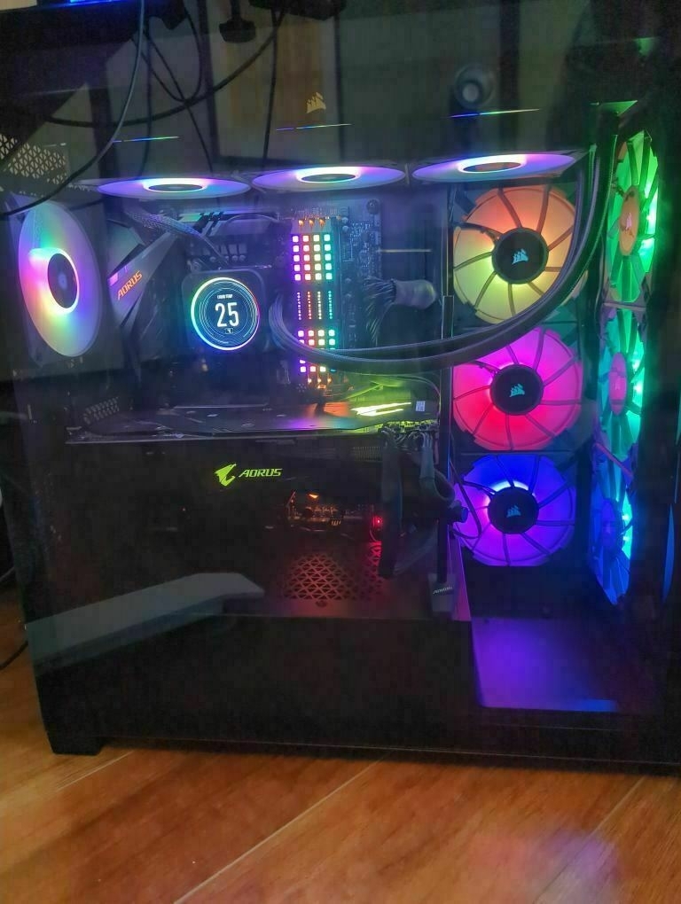 My PC with Liquid Cooled CPU Cooler A gaming PC with colorful RGB lighting and multiple cooling fans is displayed through a transparent side panel.