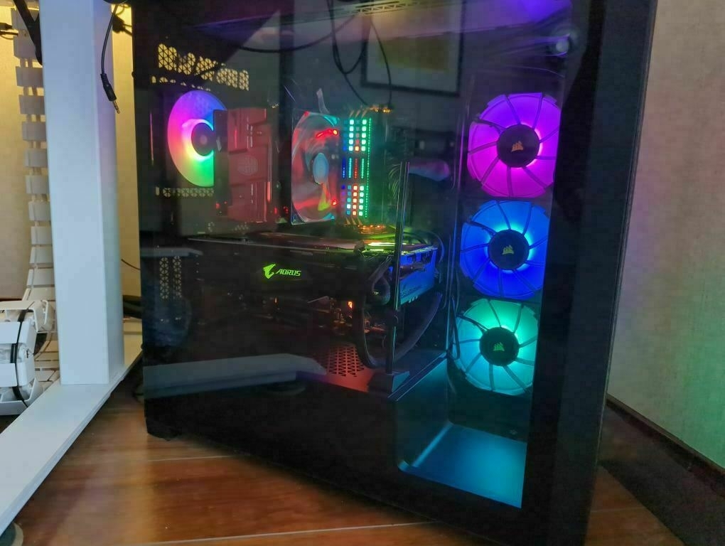 Photo of PC with large cooler fan A gaming PC with RGB lighting inside a glass-fronted case displays vibrant colours and internal components.